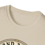 I Stand Amazed Golden Retriever T-Shirt close-up of the neckline on a sand shirt, showing the top arc of the circular golden retriever graphic.