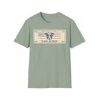 In Dog We Trust Bill T-Shirt flat lay in sage green, featuring a currency-style graphic of a dog portrait with a halo set against a vintage American flag, printed with the text 'In Dog We Trust.'