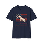 Pursuit of Fetch T-Shirt flat lay in navy blue, featuring a leaping dog catching a tennis ball over a flag of red stripes and stars, with text reading 'Life, Liberty, and the Pursuit of Fetch.'