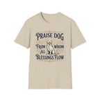 Praise Dog From Whom All Blessings Flow Golden Retriever T-Shirt flat lay in natural tan, featuring a vintage-style graphic of a seated golden retriever with a glowing halo, surrounded by ornate scroll flourishes and paw print accents.