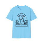 Holy Orders | Greyhound T-Shirt flat lay on navy shirt featuring a stained glass style illustration of a Greyhound depicted as a holy figure with a golden halo and the text 'Holy Orders.'
