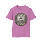 Saint Pretzel Forgive Us T-Shirt flat lay on lilac pink shirt featuring an engraved medallion design with a French Bulldog saint and the text St. Pretzel Forgive Us.