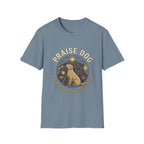 Praise Dog From Whom All Blessings Flow Labrador T-Shirt flat lay in slate blue, featuring a circular badge graphic of a golden Labrador gazing upward at a sunburst, surrounded by icons of a bone, tennis ball, paw print, and smiley face.