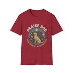 Praise Dog From Whom All Blessings Flow Labrador T-Shirt flat lay in cardinal red, featuring a circular badge graphic of a golden Labrador gazing upward at a sunburst, surrounded by icons of a bone, tennis ball, paw print, and smiley face.