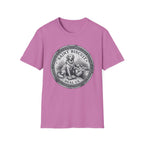 Saint Biscuit Heal Us T-shirt flat lay in lilac pink, featuring a vintage-style medallion graphic of a golden retriever dog watching over a reclining figure with the text 'Saint Biscuit Heal Us'.