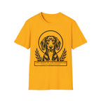 Holy Orders | Dachshund T-Shirt flat lay on sage green shirt featuring a stained glass style illustration of a Dachshund depicted as a holy figure with a golden halo and the text 'Holy Orders.'