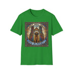 Holy Holy Holy St Bernard T-Shirt flat lay on green, featuring a stained-glass-style illustration of a St Bernard seated before cathedral arches with the text 'Holy Holy Holy Lord Dog Almighty'.