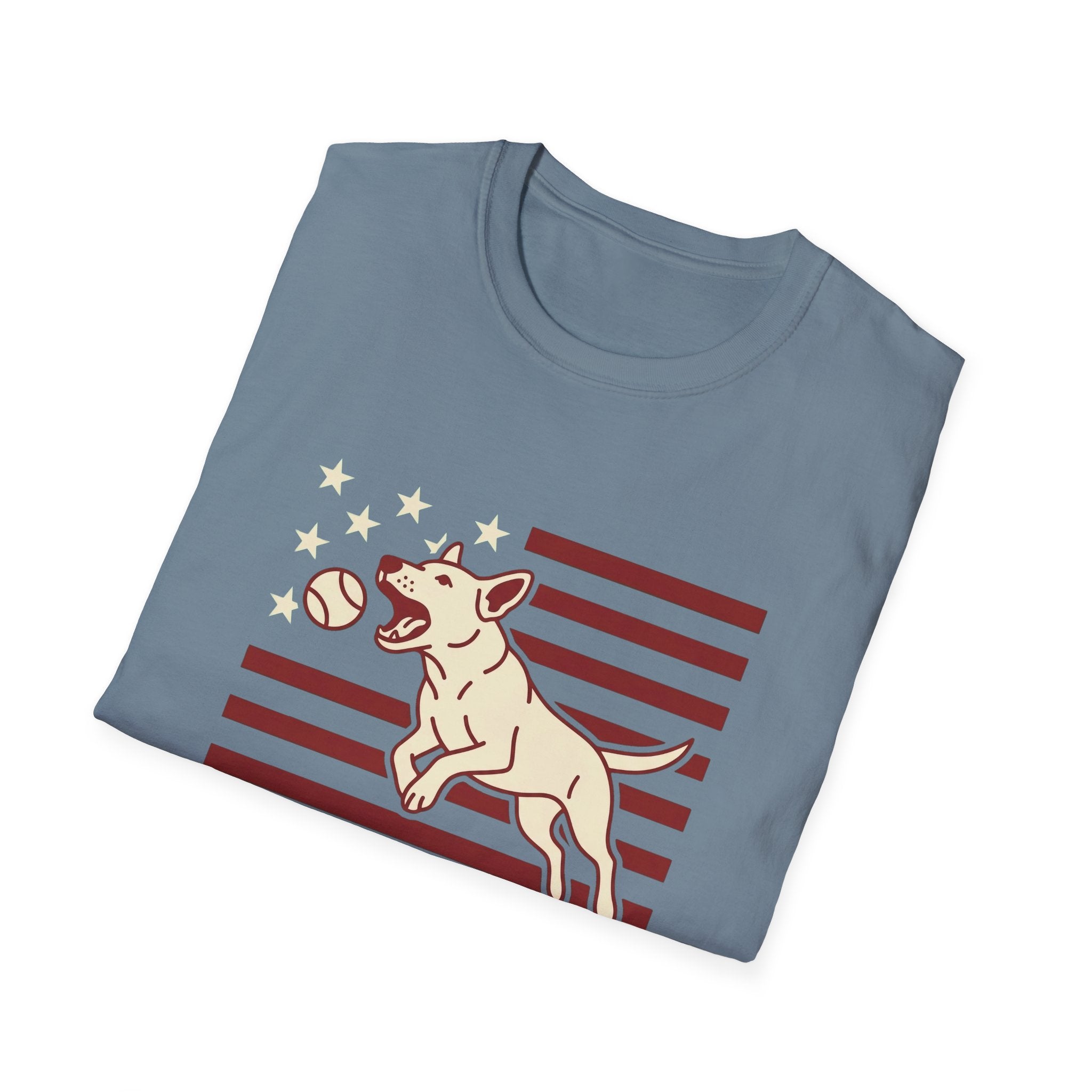 Pursuit of Fetch T-Shirt in slate blue, folded view showing the leaping dog catching a tennis ball over a flag of red stripes and stars graphic on the chest.