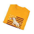 Pursuit of Fetch T-Shirt in gold yellow, folded view showing the leaping dog catching a tennis ball over a flag of red stripes and stars graphic on the chest.