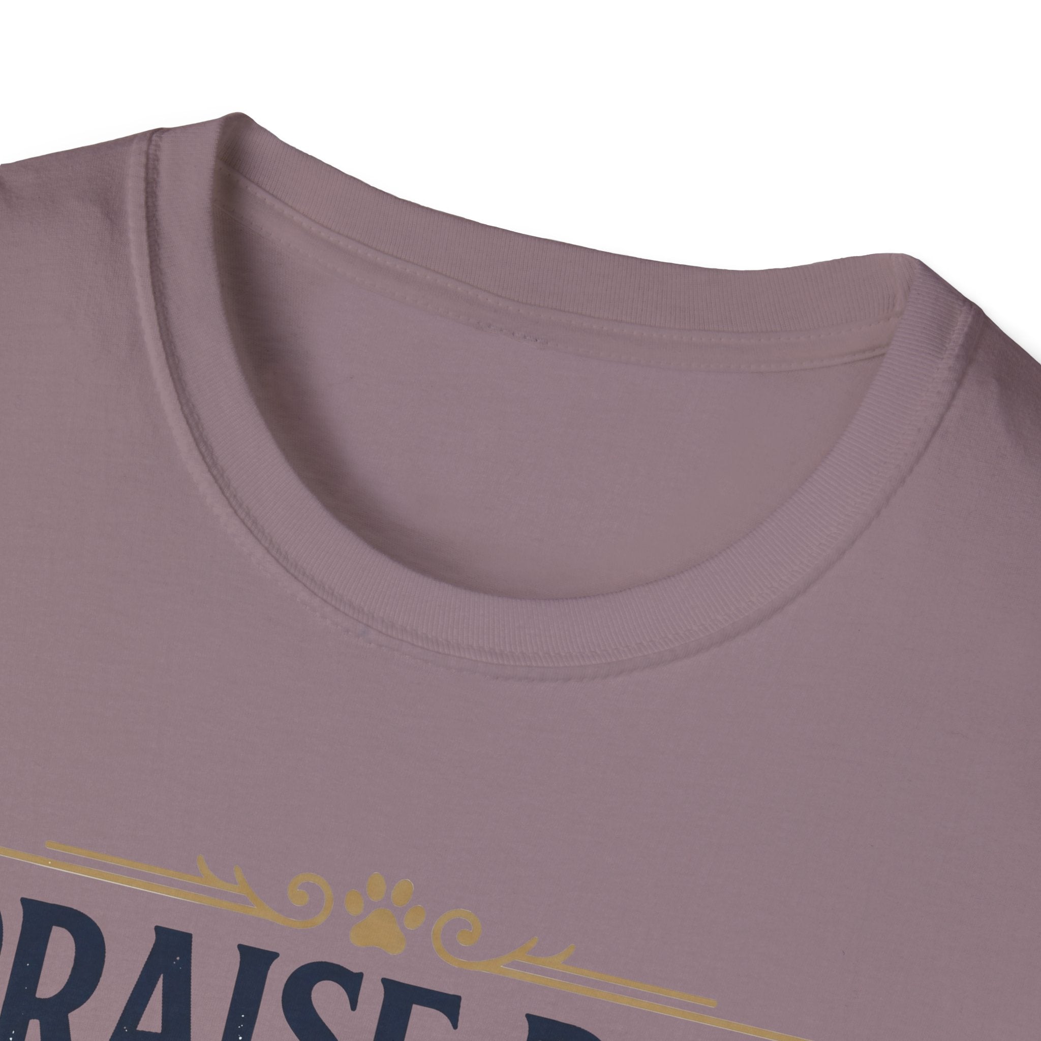 Praise Dog From Whom All Blessings Flow Golden Retriever T-Shirt close-up detail of the collar area on a dusty mauve shirt, showing paw print and scroll accents of the Praise Dog graphic.