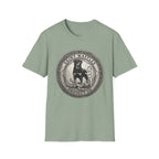 Saint Waffles Protect Us T-Shirt flat lay in sage green, featuring a vintage medallion graphic of a Rottweiler standing protectively beside a small child with the text Saint Waffles Protect Us.