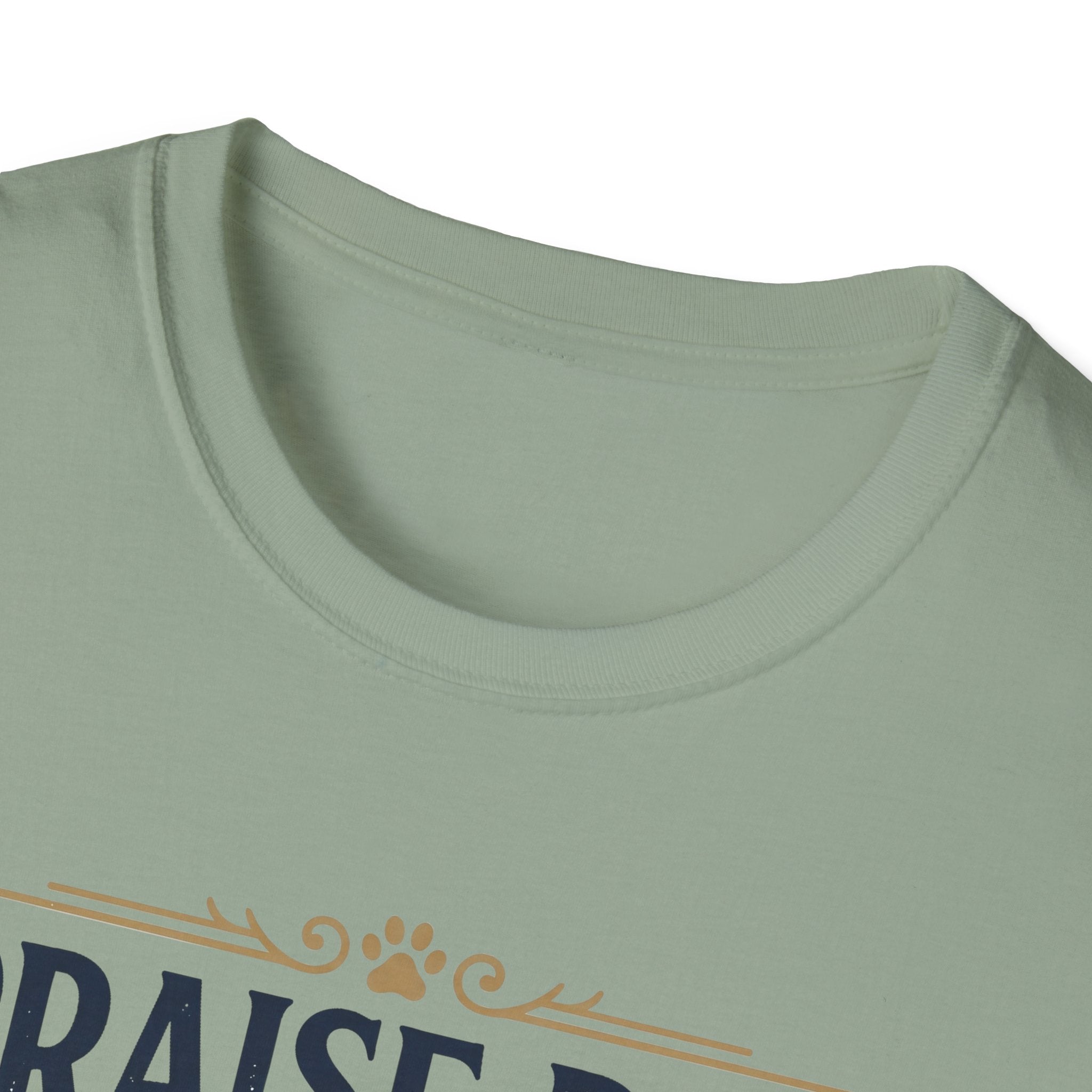 Praise Dog From Whom All Blessings Flow Golden Retriever T-Shirt close-up detail of the collar area on a sage green shirt, showing paw print and scroll accents of the Praise Dog graphic.