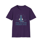 One Nation Under Dog T-Shirt flat lay in purple, featuring a blue dog silhouette seated before a rising sun with rays and surrounding stars, with bold text reading 'One Nation Under Dog.'