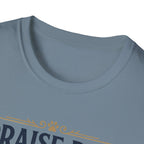 Praise Dog From Whom All Blessings Flow Golden Retriever T-Shirt close-up detail of the collar area on a slate blue shirt, showing paw print and scroll accents of the Praise Dog graphic.