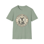 I Stand Amazed Chihuahua T-Shirt in sage green, flat lay front view featuring a vintage-style circular graphic of a Chihuahua with a halo seated above a small human figure bowing in reverence, with the text 'I Stand Amazed in the Presence of Dog.'
