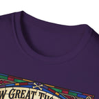 How Great Thou Bark Golden Retriever T-shirt close-up detail shot on a purple shirt, showing the colorful stained-glass style graphic with crossbones and 'How Great Thou Bark' lettering at the neckline.