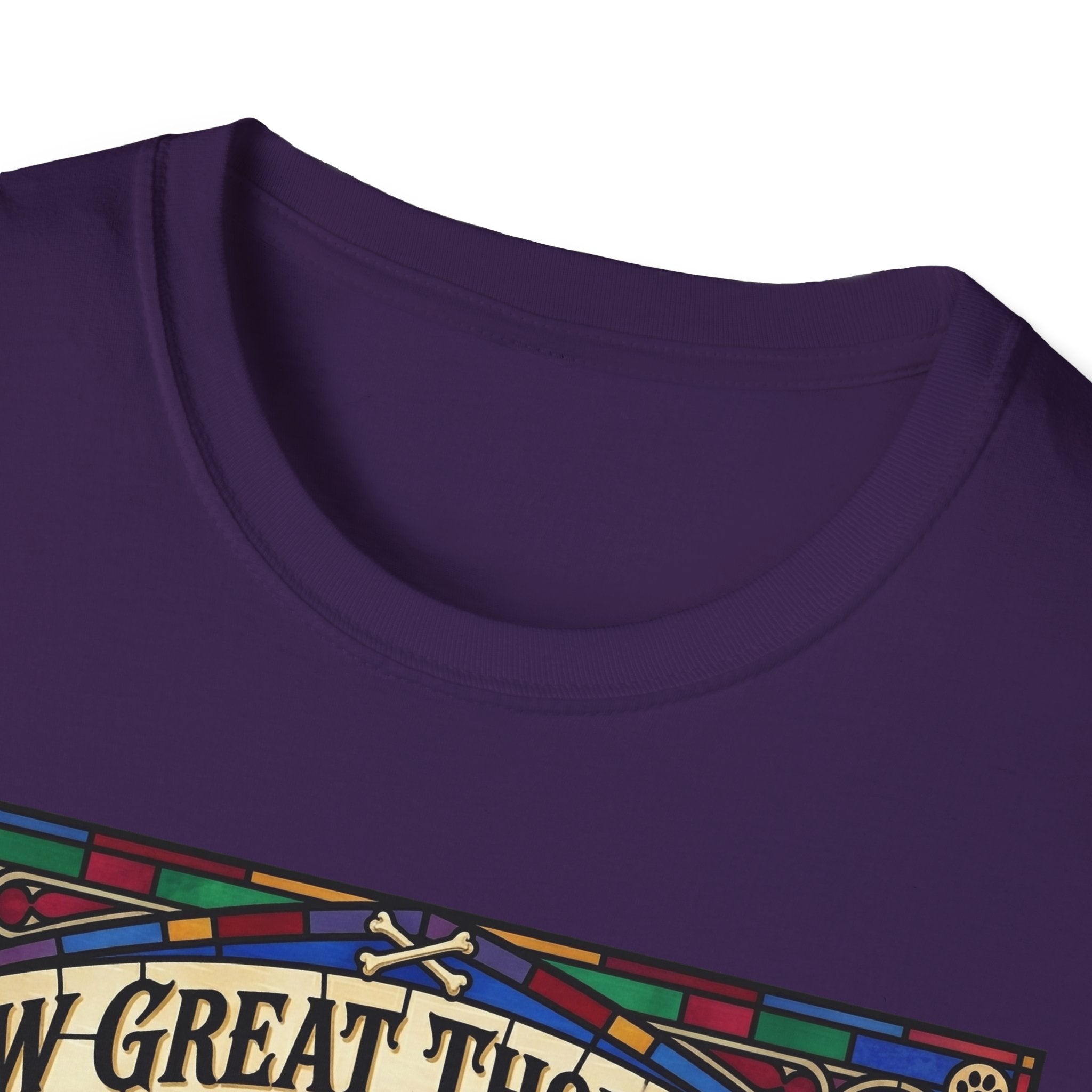 How Great Thou Bark Golden Retriever T-shirt close-up detail shot on a purple shirt, showing the colorful stained-glass style graphic with crossbones and 'How Great Thou Bark' lettering at the neckline.