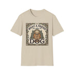 What a Friend We Have in Dog T-Shirt flat lay, natural tan shirt featuring a vintage botanical-framed graphic of a golden retriever with a halo seated before a cathedral archway with the text 'What a Friend We Have in Dog.'