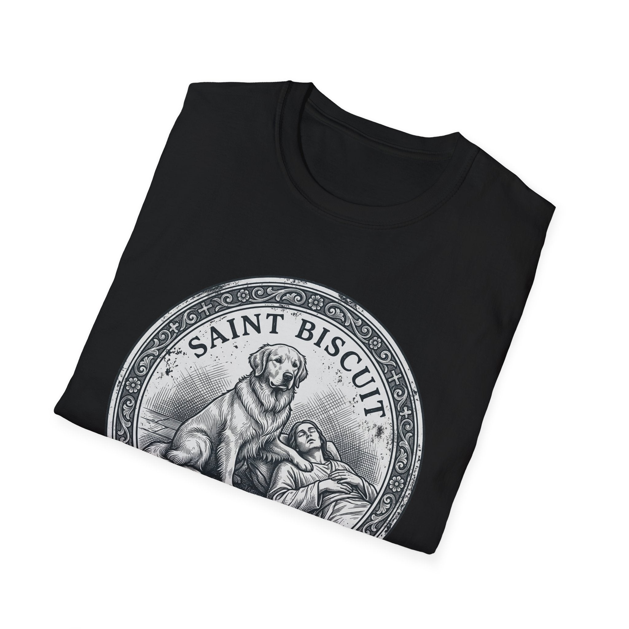Saint Biscuit Heal Us T-shirt folded flat lay in black, showing the 'Saint Biscuit' medallion graphic with a golden retriever comforting a reclining figure.
