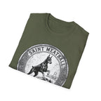 Saint Meatball Defend Us T-Shirt folded flat lay on military green shirt showing the Doberman saint medallion design.