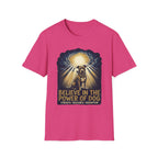 Believe in the Power Pitbull Clouds T-Shirt in hot pink, flat lay, featuring a dramatic illustrated graphic of a brindle Pitbull standing before a burst of heavenly light breaking through storm clouds, with text reading Believe in the Power of Dog and Strength, Resilience, Redemption.