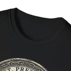 Saint Pretzel Forgive Us T-Shirt close-up detail shot on black shirt showing the neckline and top portion of the St. Pretzel engraved medallion graphic.