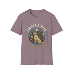 Praise Dog From Whom All Blessings Flow Labrador T-Shirt flat lay in dusty mauve, featuring a circular badge graphic of a golden Labrador gazing upward at a sunburst, surrounded by icons of a bone, tennis ball, paw print, and smiley face.