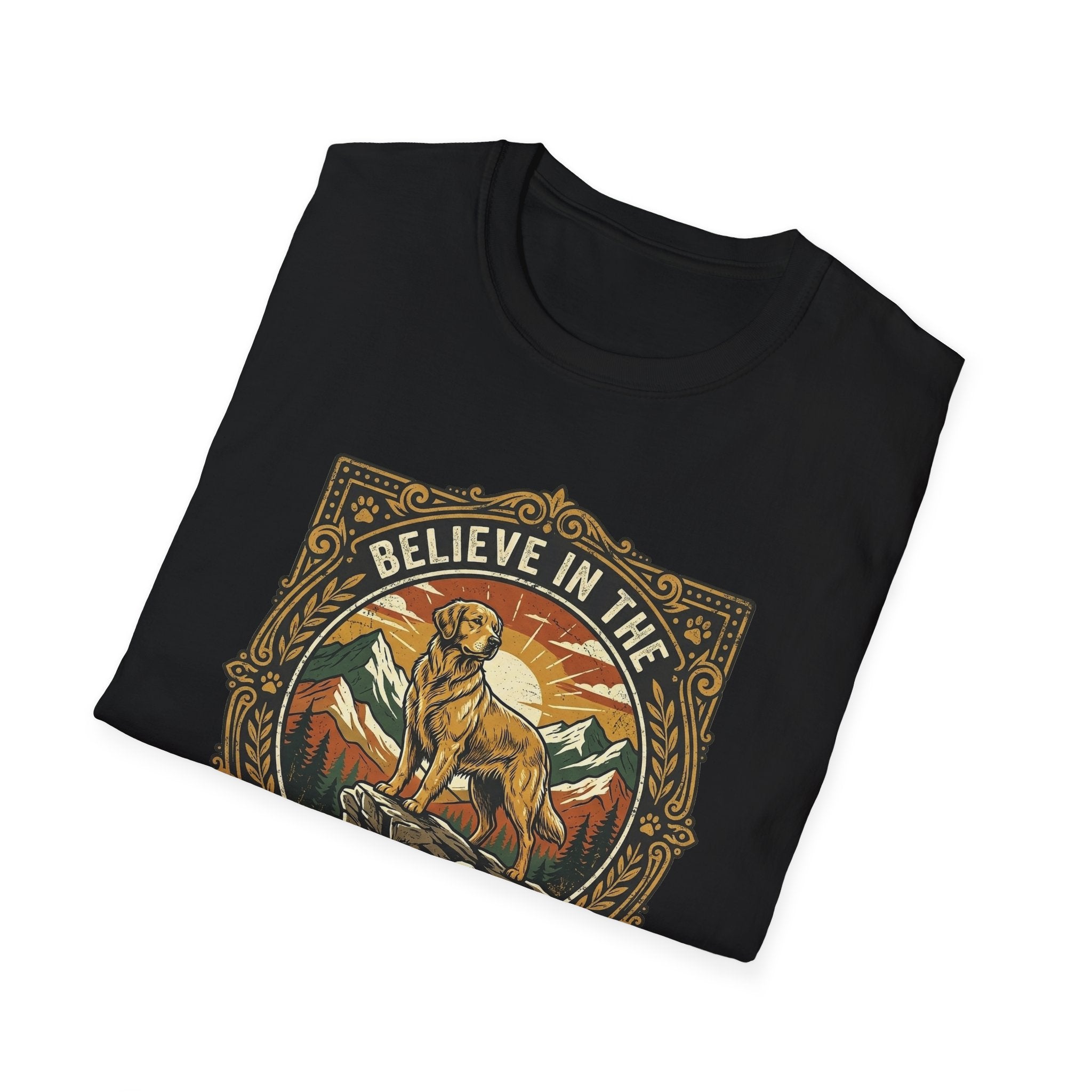 Believe in the Power of Dog T-shirt folded flat lay in black, showing the ornate vintage badge graphic of a Labrador on a rocky mountain outcrop with 'Believe in the' arched text at top.