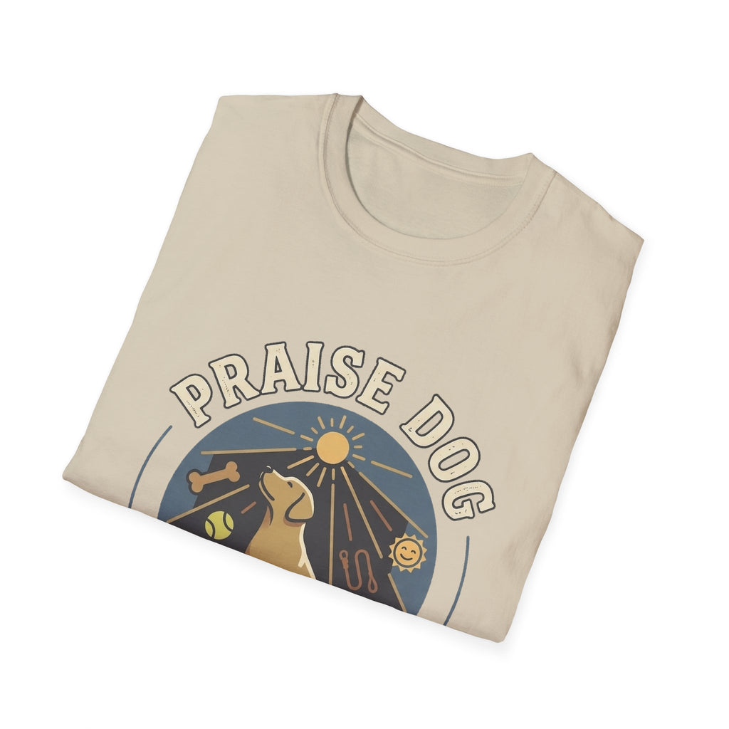 Praise Dog From Whom All Blessings Flow Labrador T-Shirt folded view in natural tan, showing the Praise Dog sunburst badge graphic with a golden Labrador at center.