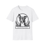 Holy Orders | Lobo T-Shirt flat lay on navy shirt featuring a stained glass style illustration of Lobo, a black-coated dog with a white blaze and large upright ears, depicted as a holy figure with a golden halo and the text 'Holy Orders.'