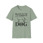 Believe in the Power of Dog T-Shirt flat lay in sage green, featuring a bold line-art dog outline and the text Believe in the Power of Dog with a paw print in the letter O.