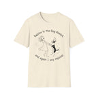 Rejoice in the Dog T-Shirt in natural cream, flat lay, featuring a playful line drawing of a woman joyfully dancing with a leaping dog and the text 'Rejoice in the Dog Always, and again I say rejoice!'