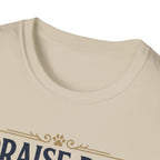 Praise Dog From Whom All Blessings Flow Golden Retriever T-Shirt close-up detail of the collar area on a natural tan shirt, showing paw print and scroll accents of the Praise Dog graphic.