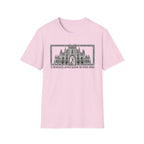 A Mighty Fortress is Our Dog T-Shirt flat lay in light pink featuring a detailed gothic cathedral illustration with a dog standing in the doorway, framed in an ornate border with text below.
