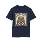 What a Friend We Have in Dog T-Shirt flat lay, navy blue shirt featuring a vintage botanical-framed graphic of a golden retriever with a halo seated before a cathedral archway with the text 'What a Friend We Have in Dog.'