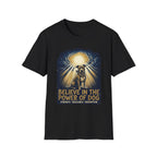 Believe in the Power Pitbull Clouds T-Shirt in black, flat lay, featuring a dramatic illustrated graphic of a brindle Pitbull standing before a burst of heavenly light breaking through storm clouds, with text reading Believe in the Power of Dog and Strength, Resilience, Redemption.