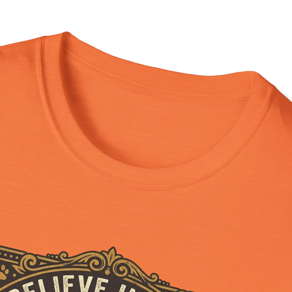 Believe in the Power of Dog T-shirt close-up detail on orange shirt showing the ornate gold border and 'Believe In The' text of the vintage badge graphic.