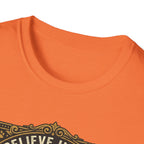 Believe in the Power of Dog T-shirt close-up detail on orange shirt showing the ornate gold border and 'Believe In The' text of the vintage badge graphic.