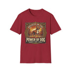 Believe in the Power of Dog Pitbull Cityscape T-Shirt in cardinal red, flat lay, featuring a retro-style badge graphic of a muscular brown and white Pitbull standing proudly before a warm urban cityscape at sunset, with text reading Believe in the Power of Dog and Strength, Heart, Loyalty.