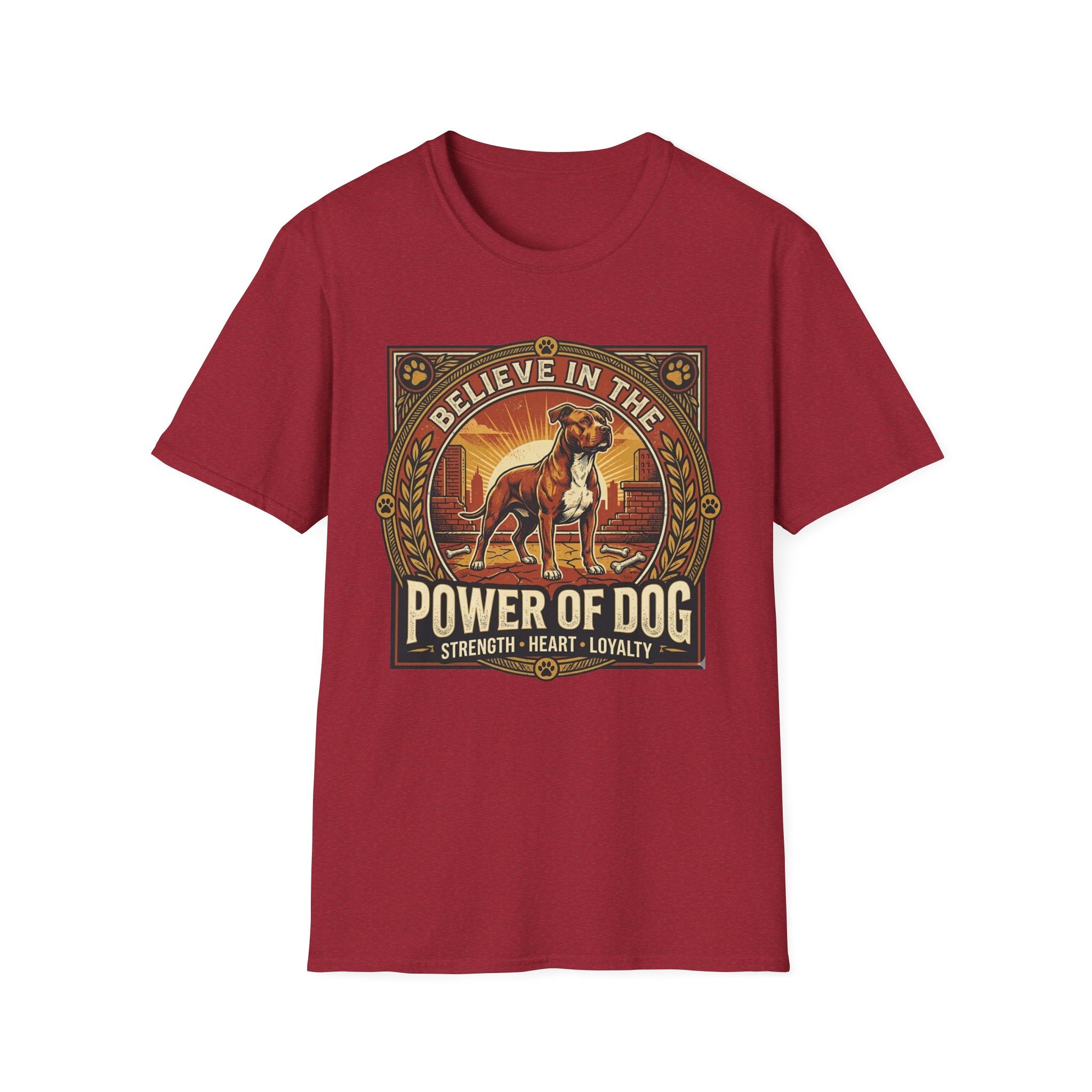 Believe in the Power of Dog Pitbull Cityscape T-Shirt in cardinal red, flat lay, featuring a retro-style badge graphic of a muscular brown and white Pitbull standing proudly before a warm urban cityscape at sunset, with text reading Believe in the Power of Dog and Strength, Heart, Loyalty.