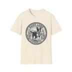 Saint Lobo Gather Us T-Shirt flat lay in natural/cream, featuring a vintage medallion graphic of a leaping border collie-style dog with a halo, surrounded by the text 'Saint Lobo — Gather Us.'