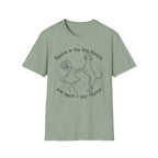 Rejoice in the Dog Rhodesian Ridgeback T-Shirt in sage green, flat lay mockup showing a woman joyfully dancing with a rearing Rhodesian Ridgeback line-art illustration and the text 'Rejoice in the Dog Always, and again I say rejoice!'
