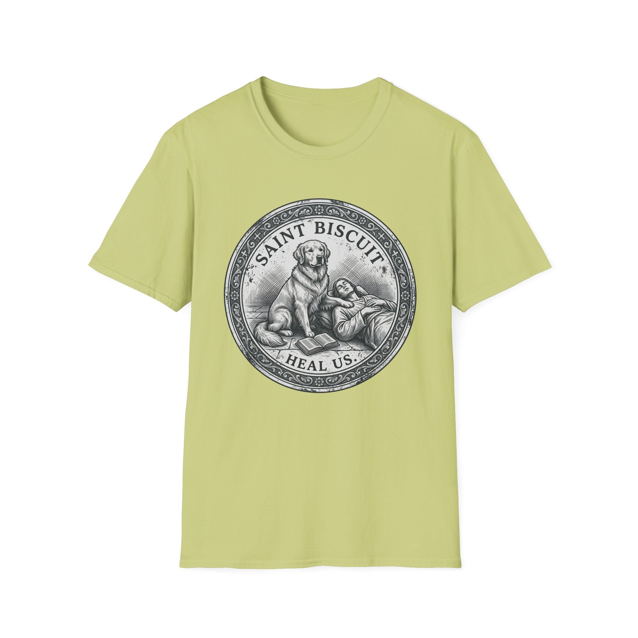 Saint Biscuit Heal Us T-shirt flat lay in light yellow-green, featuring a vintage-style medallion graphic of a golden retriever dog watching over a reclining figure with the text 'Saint Biscuit Heal Us'.
