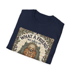 What a Friend We Have in Dog T-Shirt folded view, navy blue shirt showing the graphic of a golden retriever with halo framed by oak leaves, thistles, and paw prints with the text 'What a Friend We Have in Dog.'