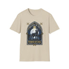 Believe in the Power of Dog Black Lab T-Shirt in sand natural, flat lay view showing a gothic arch-framed graphic of a halo-wearing black Labrador standing under a full moon with a starry night sky, paw prints, crossed bones, and the words 'Strength Devotion Love'.