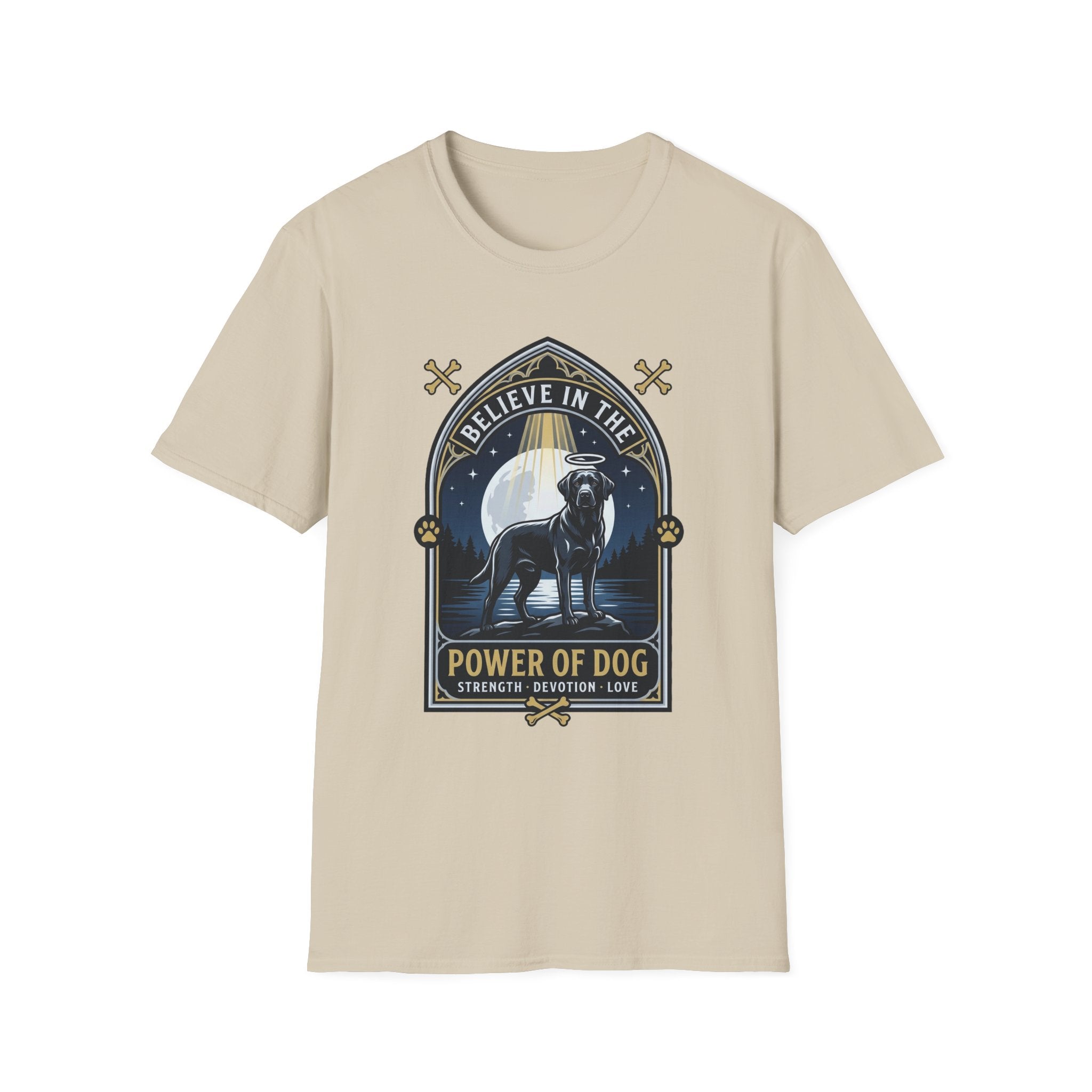 Believe in the Power of Dog Black Lab T-Shirt in sand natural, flat lay view showing a gothic arch-framed graphic of a halo-wearing black Labrador standing under a full moon with a starry night sky, paw prints, crossed bones, and the words 'Strength Devotion Love'.