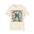 Praise Dog From Whom All Blessings Flow Geometric T-Shirt flat lay in natural tan, featuring a bold pop-art style graphic of a colorful geometric dog with a halo, surrounded by stars, thumbs up, and dog toy icons in vivid primary colors.