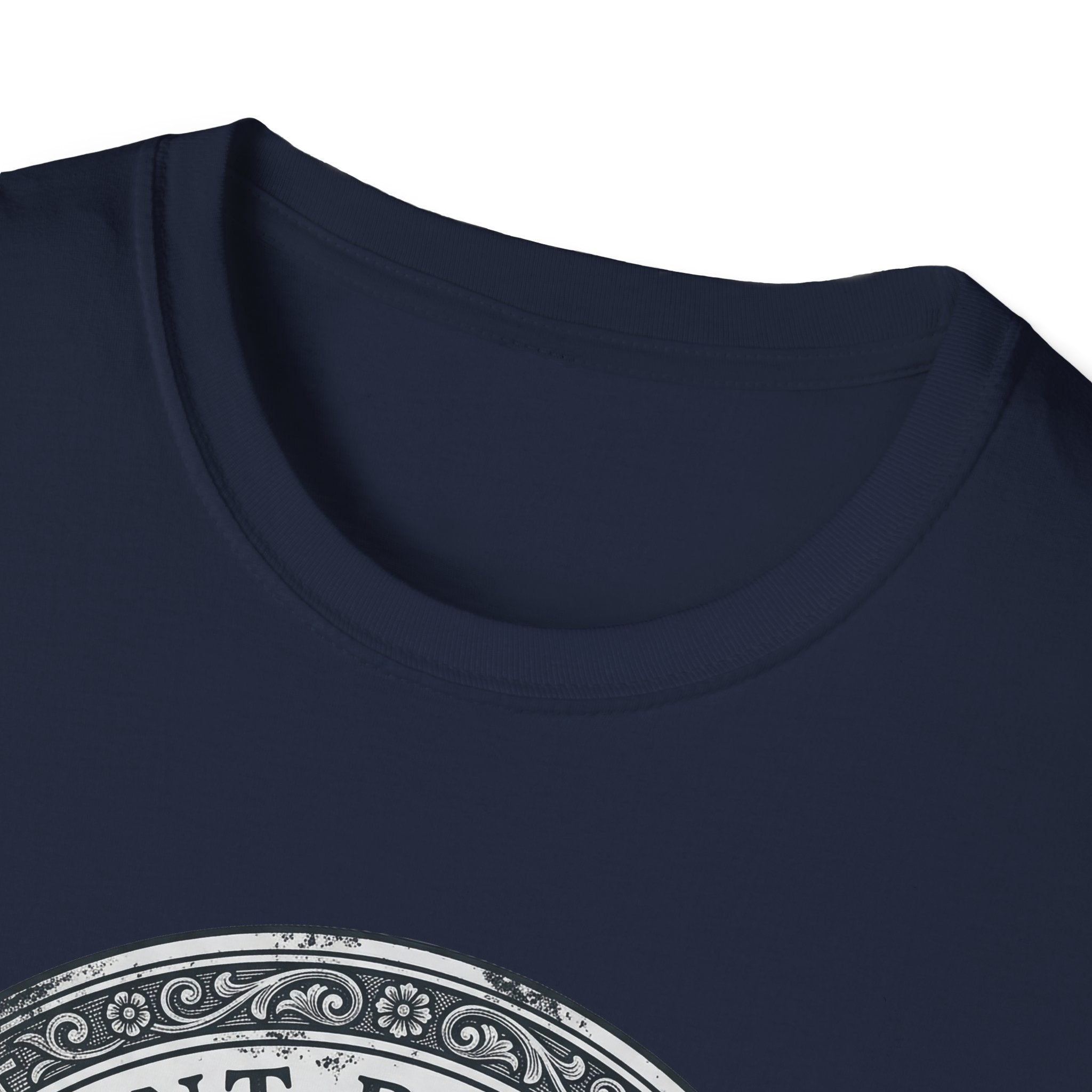 Saint Biscuit Heal Us T-shirt close-up detail on navy blue shirt showing the ornate circular border and 'Saint Biscuit' text of the vintage medallion graphic.