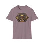 Praise Dog From Whom All Blessings Flow Corgi T-Shirt flat lay in dusty mauve, featuring an ornate medieval stained-glass style graphic of a regal corgi seated in a jewel-encrusted octagonal frame with gold gothic lettering and dog bone and tennis ball accents.