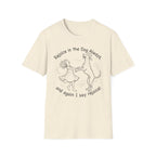 Rejoice in the Dog Rhodesian Ridgeback T-Shirt in natural cream, flat lay mockup showing a woman joyfully dancing with a rearing Rhodesian Ridgeback line-art illustration and the text 'Rejoice in the Dog Always, and again I say rejoice!'